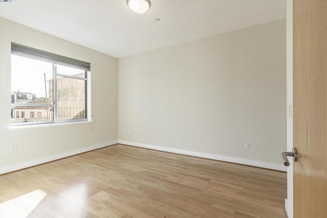 spare room with light hardwood / wood-style flooring