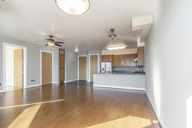 unfurnished living room with ceiling fan and dark hardwood / wood-style floors