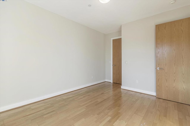 unfurnished room with light hardwood / wood-style floors