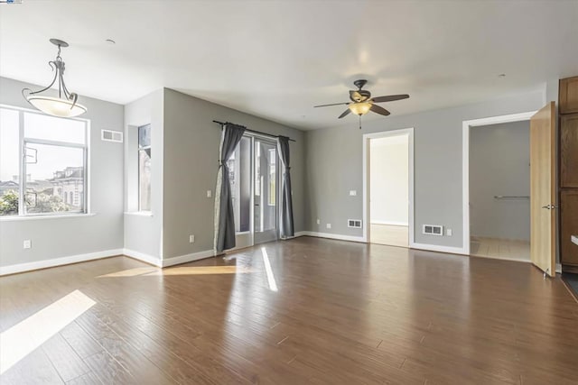 unfurnished room featuring ceiling fan and dark wood-type flooring