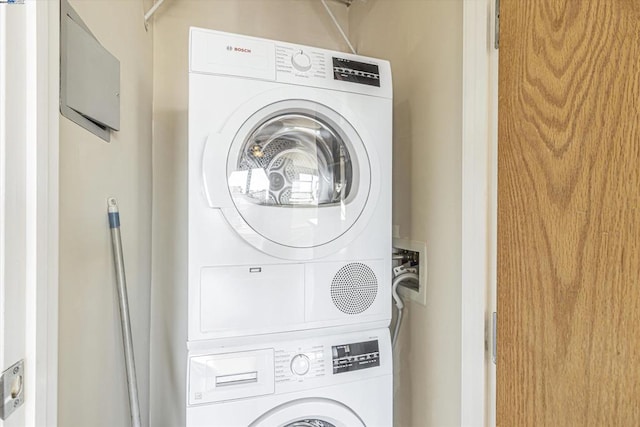 laundry area with stacked washer and clothes dryer