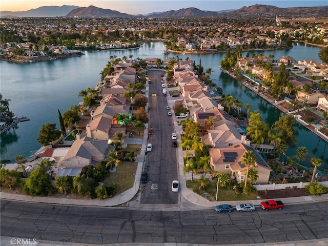 aerial view at dusk with a water and mountain view