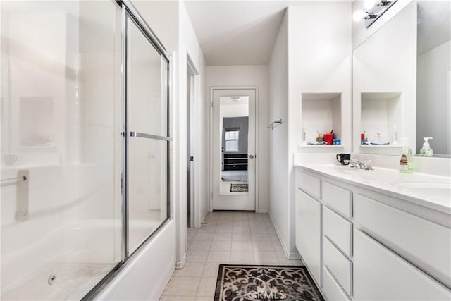 bathroom featuring bath / shower combo with glass door, tile patterned floors, and vanity