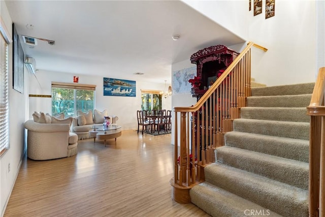 interior space featuring an inviting chandelier and hardwood / wood-style flooring