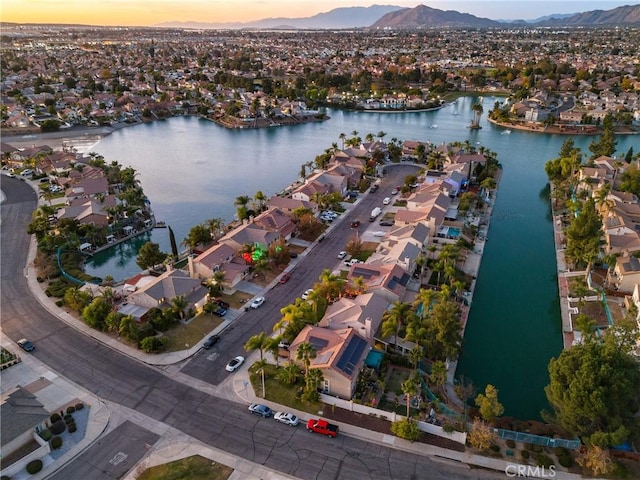 aerial view at dusk with a water and mountain view