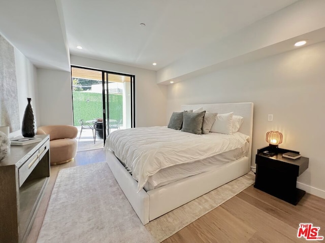 bedroom featuring access to outside and light hardwood / wood-style flooring