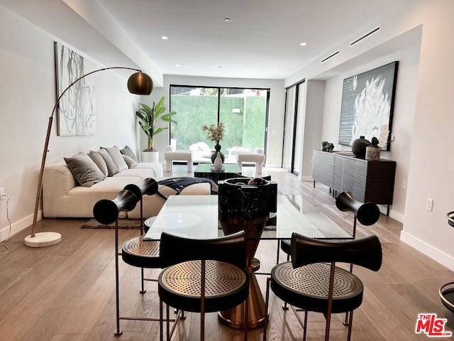 dining space with light wood-type flooring