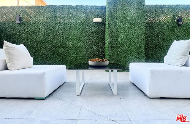 living area with tile patterned flooring and a healthy amount of sunlight