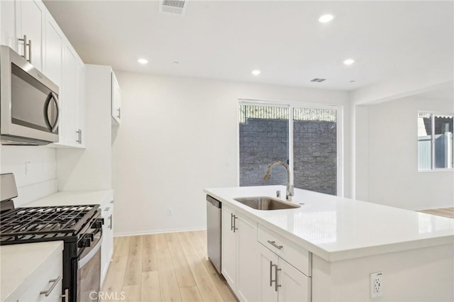 34260 Summer Ln, Yucaipa, CA 92399 - kitchen with appliances with stainless steel finishes, a sink, light wood-style floors, light countertops, and recessed lighting