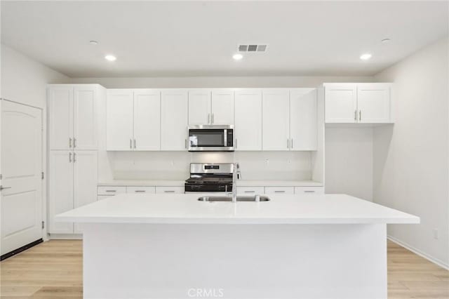34260 Summer Ln, Yucaipa, CA 92399 - kitchen featuring stainless steel appliances, a sink, white cabinets, light wood-style floors, and recessed lighting