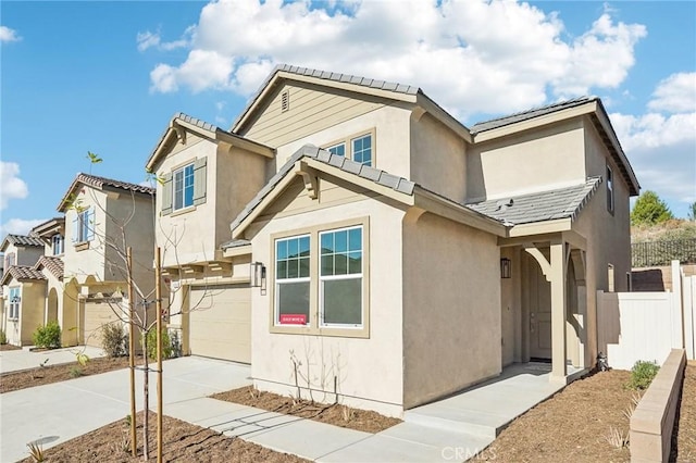 34260 Summer Ln, Yucaipa, CA 92399 - view of front of property featuring an attached garage, fence, stucco siding, driveway, and a tile roof
