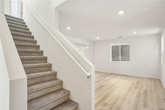 34260 Summer Ln, Yucaipa, CA 92399 - stairway featuring recessed lighting, wood finished floors, and baseboards