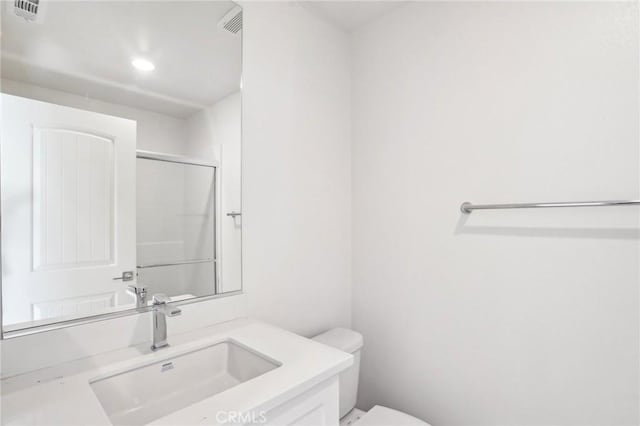 34260 Summer Ln, Yucaipa, CA 92399 - full bathroom featuring toilet, vanity, recessed lighting, and an enclosed shower
