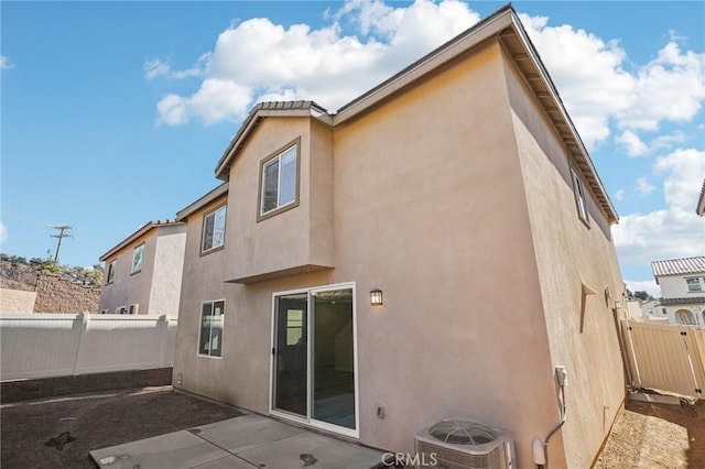 34260 Summer Ln, Yucaipa, CA 92399 - rear view of house with central air condition unit, stucco siding, a fenced backyard, and a patio area