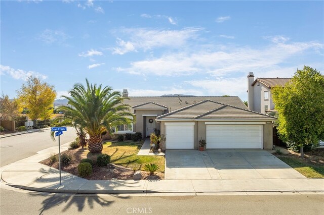 view of front of home with a front yard and a garage