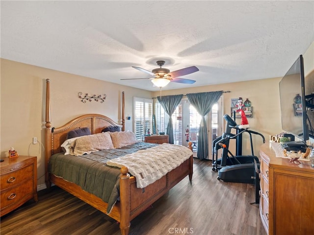 bedroom with a textured ceiling, ceiling fan, and dark hardwood / wood-style flooring