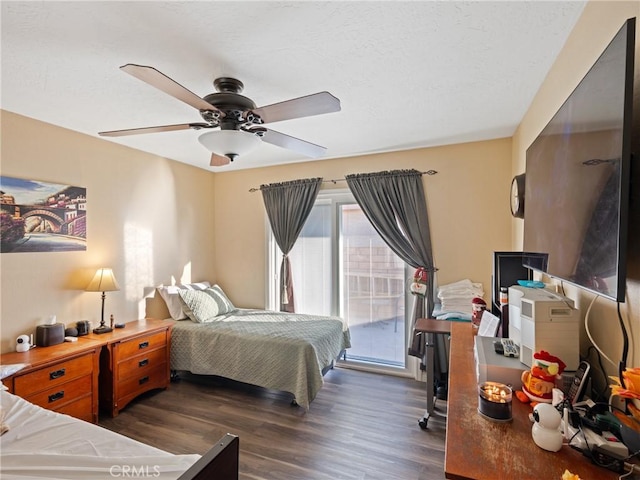 bedroom featuring ceiling fan, access to exterior, and dark wood-type flooring