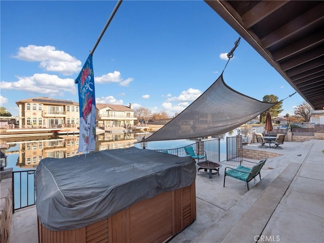 view of patio / terrace with an outdoor fire pit and a hot tub