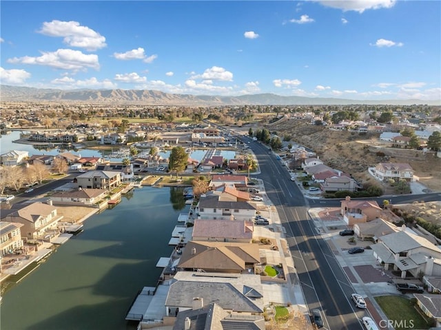 drone / aerial view featuring a water and mountain view