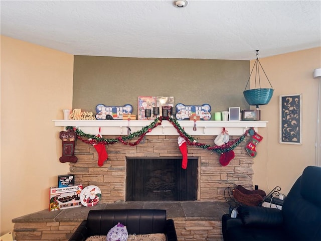 living room with a stone fireplace