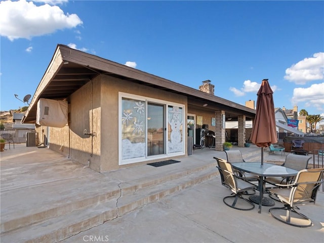 back of property with a patio area and central AC unit