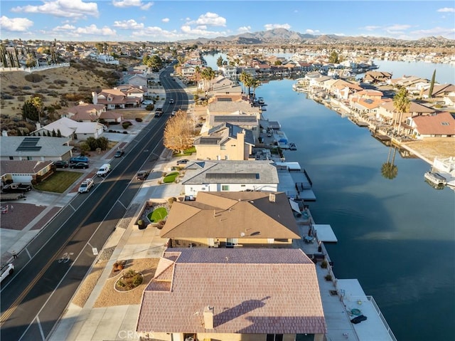 drone / aerial view featuring a water and mountain view