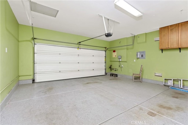 garage with a garage door opener and electric panel