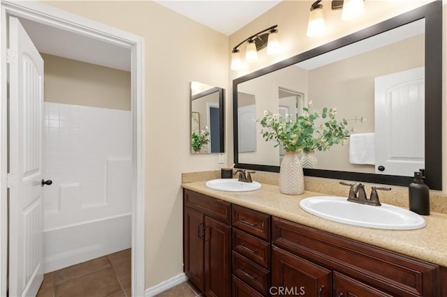 bathroom with a shower, tile patterned floors, and vanity