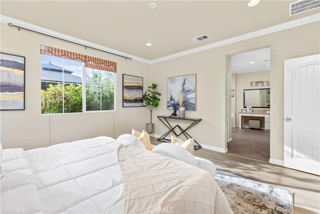 bedroom with crown molding and hardwood / wood-style floors