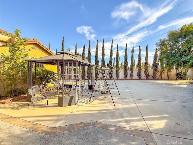 view of property's community with a playground and a gazebo