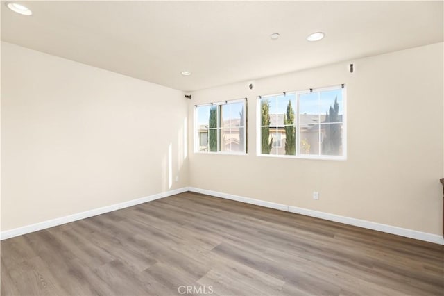 unfurnished room featuring hardwood / wood-style flooring