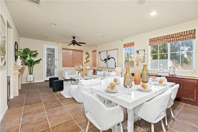 tiled dining area featuring ceiling fan