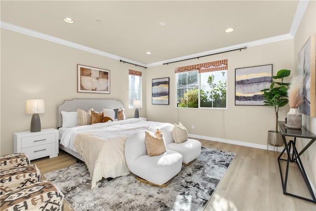 bedroom featuring light wood-type flooring and crown molding