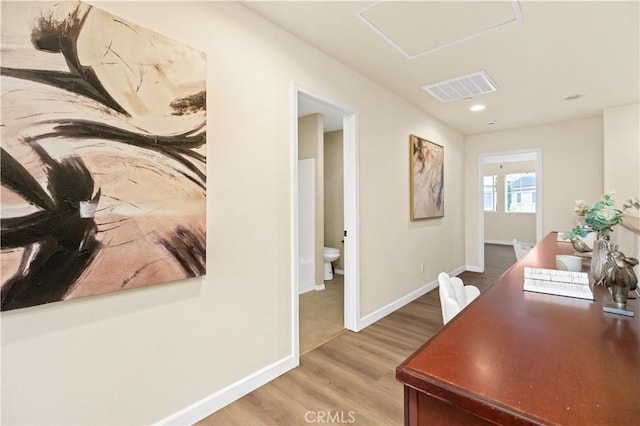 hallway with light hardwood / wood-style floors