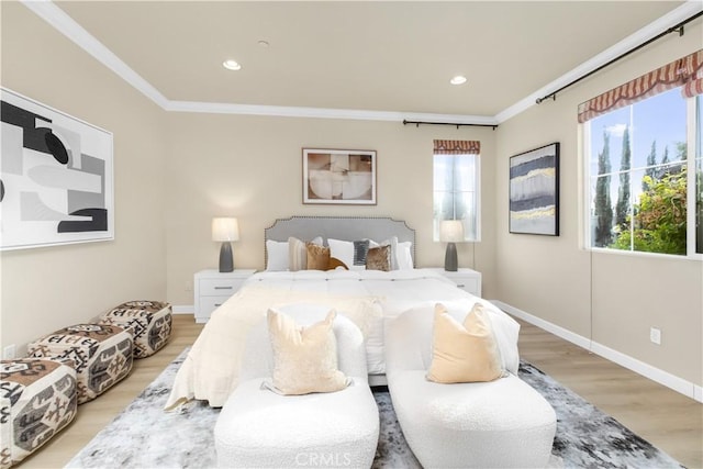 bedroom with crown molding and light wood-type flooring