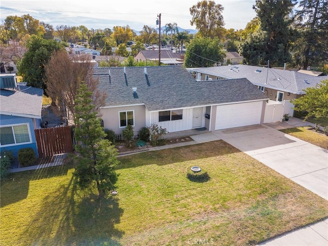 view of front of house featuring a garage, a front yard, and central air condition unit