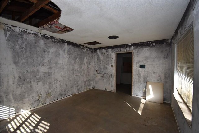 basement featuring a textured ceiling