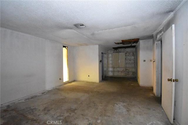 basement featuring a textured ceiling