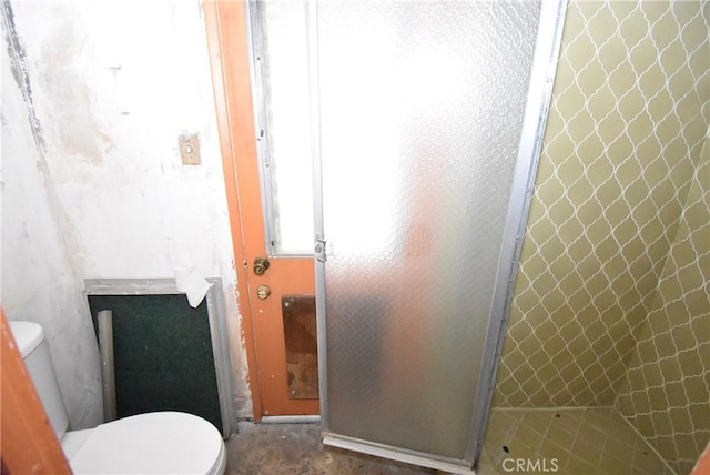 bathroom featuring toilet and walk in shower