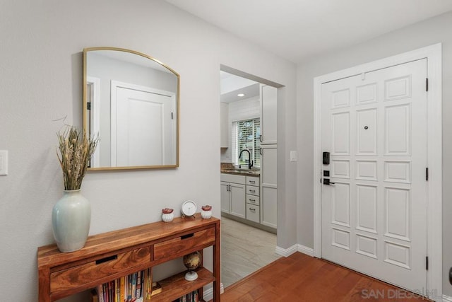 entrance foyer with light hardwood / wood-style flooring and sink