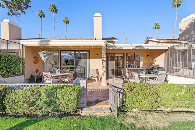 rear view of house with a patio