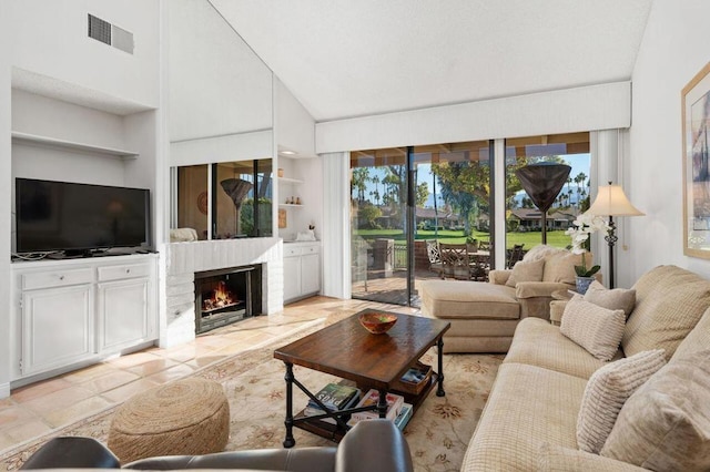 living room featuring built in shelves and a fireplace