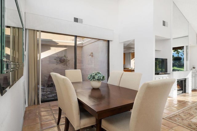 dining space featuring a high ceiling