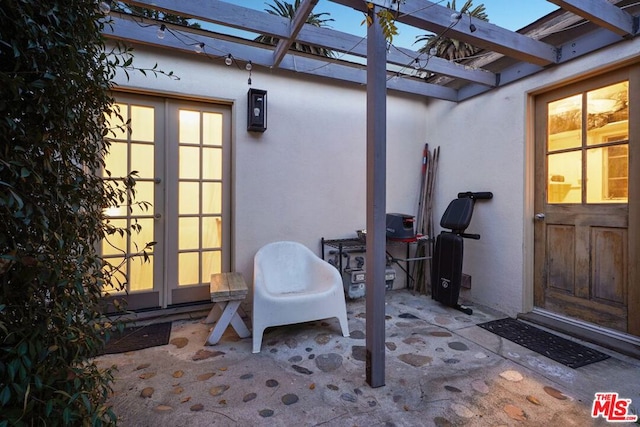 view of patio / terrace featuring french doors and a pergola