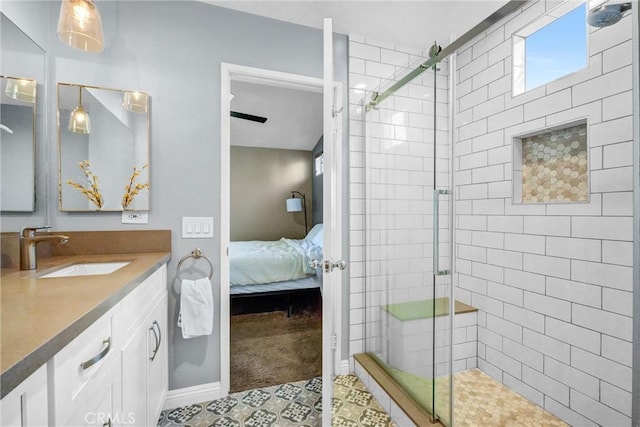 bathroom featuring a shower with door and vanity