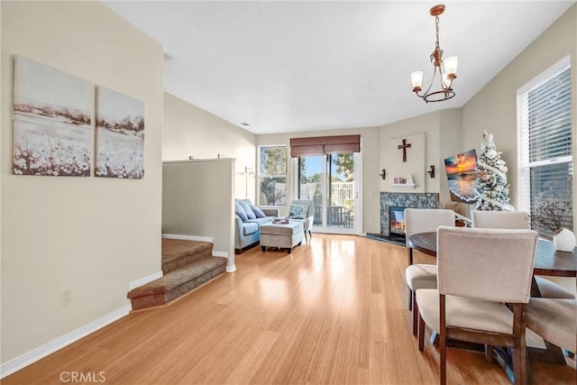 living room featuring a notable chandelier and light wood-type flooring