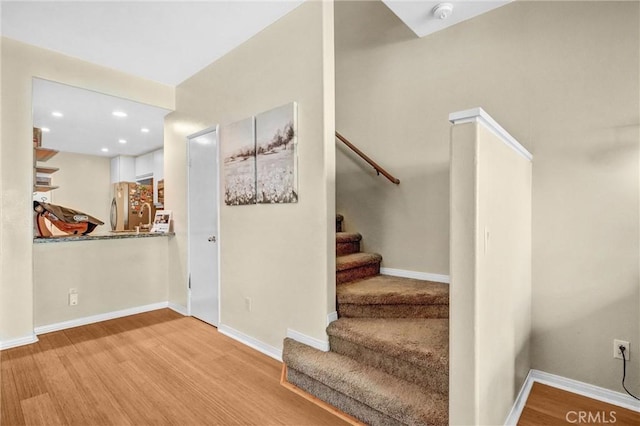 stairway featuring hardwood / wood-style floors