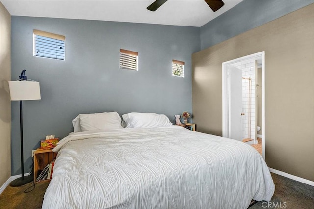 carpeted bedroom with ensuite bathroom, ceiling fan, and lofted ceiling