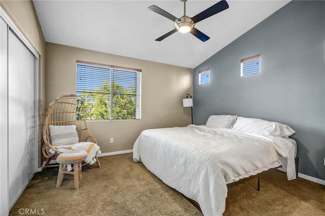 carpeted bedroom with vaulted ceiling, ceiling fan, and a closet