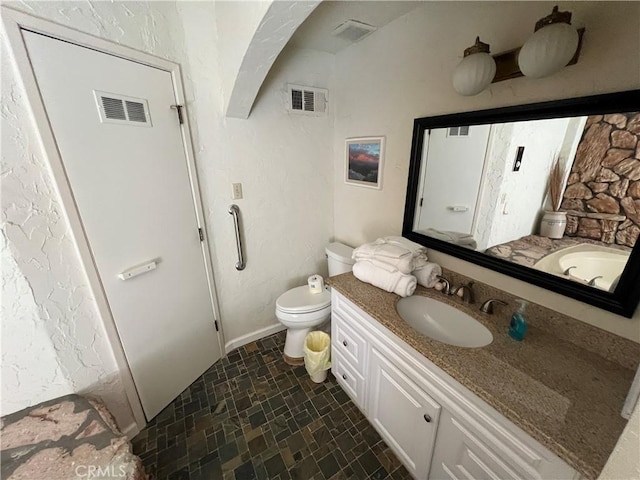 bathroom with toilet and vanity